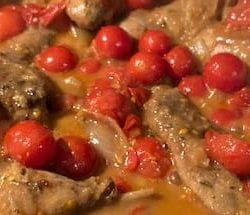 grouse with shallots and cherry tomatoes in pan