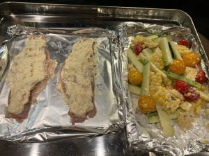 fish fillets with sauce and veggies on side to go in oven