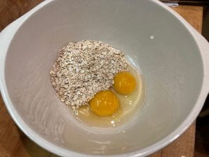2 raw eggs and oats in bowl