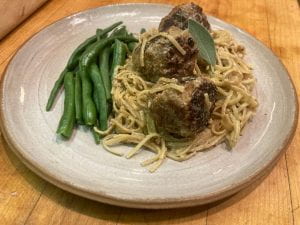 plated dish with turkey meatballs, noodles, and green beans